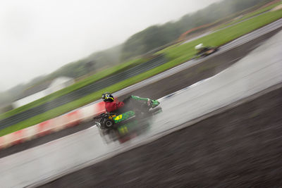 Blurred motion of man riding motorcycle on sky