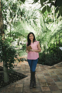Corporate portrait of a beautiful agronomical engineer in a greenhouse