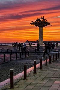 Pier in sea at sunset