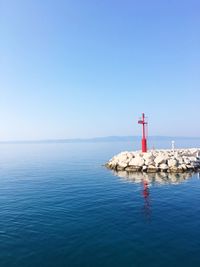 Scenic view of calm sea against clear sky