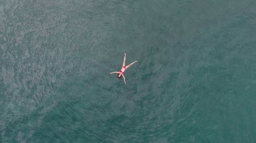 High angle view of woman flying over sea