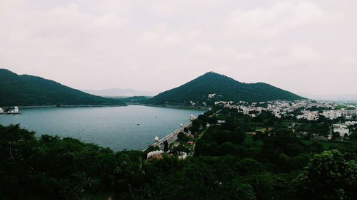 Scenic view of sea and mountains against sky