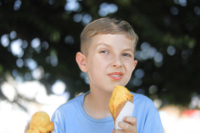 Portrait of boy eating food