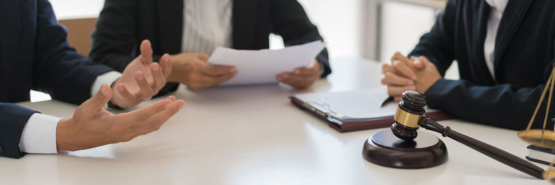 Midsection of lawyer working at desk in office