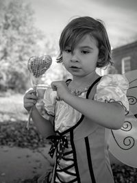 Thoughtful girl wearing butterfly costume wing