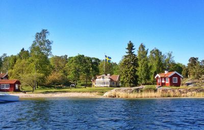 Scenic view of river and houses against sky