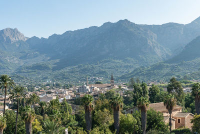 High angle view of townscape and mountains against clear sky