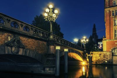 Illuminated bridge at night