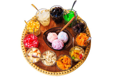 High angle view of multi colored candies against white background