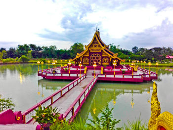 Gazebo on lake against sky