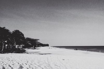 Scenic view of beach against sky during winter