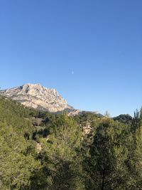 Scenic view of mountains against clear blue sky