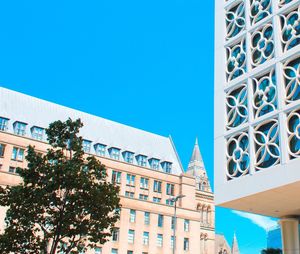 Low angle view of buildings against blue sky