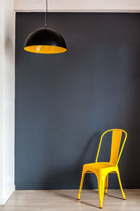 Empty chairs and table against wall at home