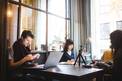 Creative coworkers working at desk in office