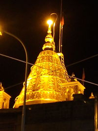 Low angle view of illuminated building against sky