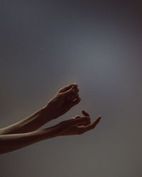 Low section of woman against blue sky