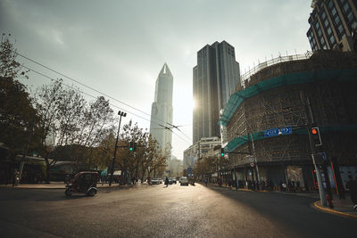 City street and buildings against sky