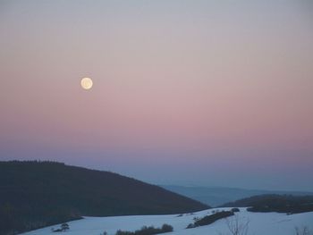 Scenic view of mountains against sky at night