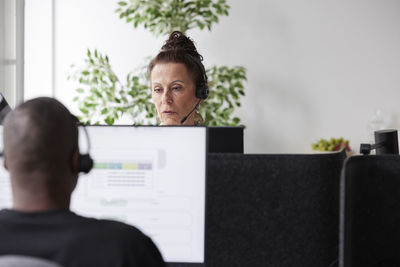 Woman wearing headset working in office