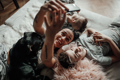 Group of people lying on bed