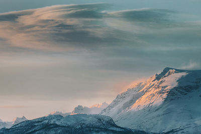 Scenic view of snowcapped mountains against sky during sunset