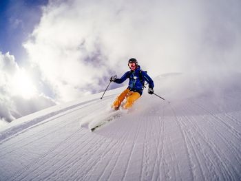 Low angle view of man skiing on mountain