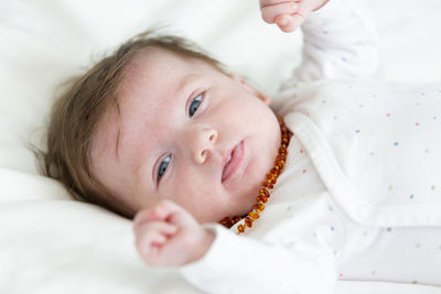 Cute baby lying on bed