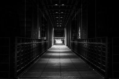 View of empty footbridge at night