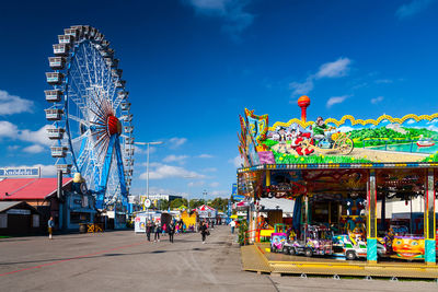 Ferris wheel at amusement park against sky