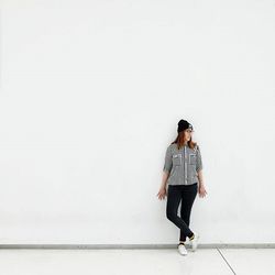 Full length of woman standing on wall