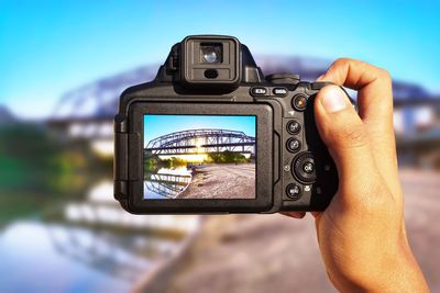 Close-up of person photographing camera on mobile phone