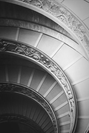 indoors, architecture, built structure, low angle view, design, pattern, ceiling, arch, architectural feature, steps, spiral staircase, staircase, spiral, railing, steps and staircases, ornate, building, no people, directly below, day