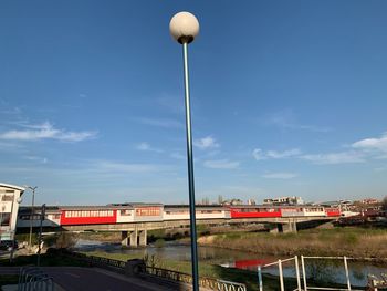 Street by road against blue sky
