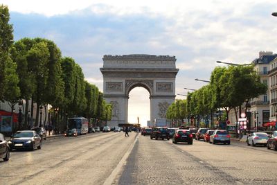 View of town square against cloudy sky