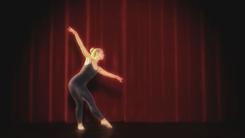 Midsection of woman standing in illuminated stage