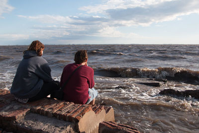 Couple sitting by the sea