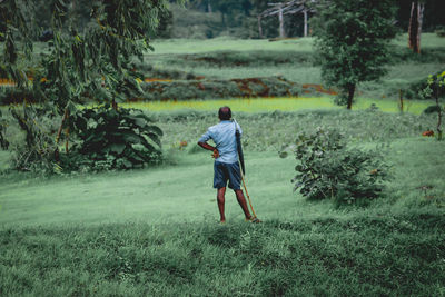 Rear view of man standing on field