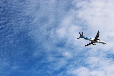 Low angle view of airplane flying in sky