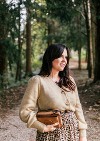 Young woman standing in a forest