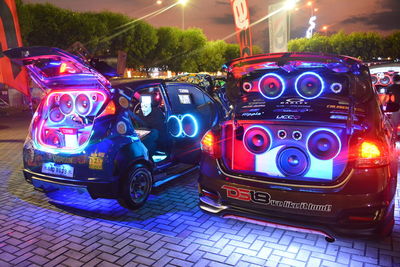 Multi colored toy car on street at night