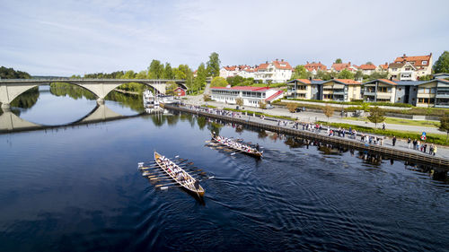 Boats in river against built structures