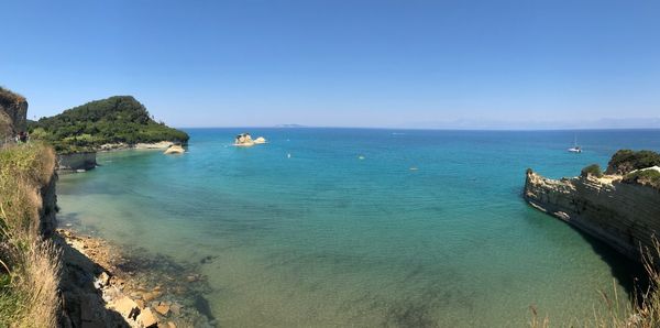 Scenic view of bay against clear sky