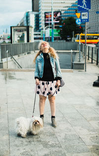 Full length of woman with dog