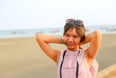Portrait of happy girl standing on beach