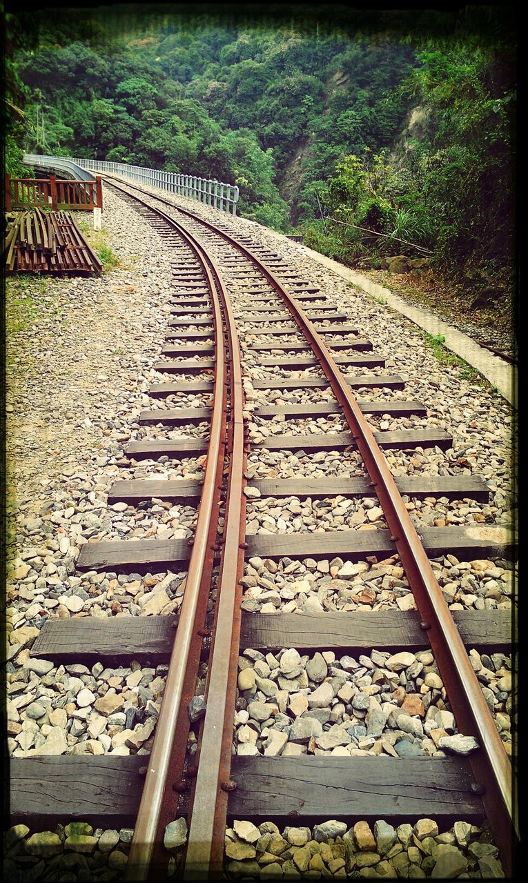 railroad track, the way forward, rail transportation, diminishing perspective, transfer print, transportation, auto post production filter, vanishing point, tree, metal, day, text, railing, no people, outdoors, plant, high angle view, long, connection, railway track