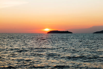 Scenic view of sea against romantic sky at sunset