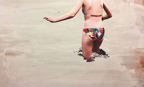 Full length of woman standing on beach