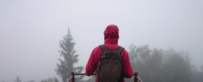 Man standing on railing 