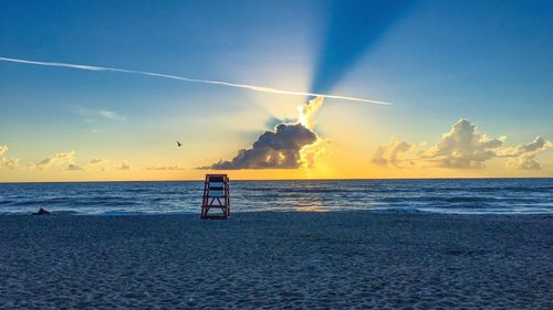 Scenic view of beach against sky during sunset